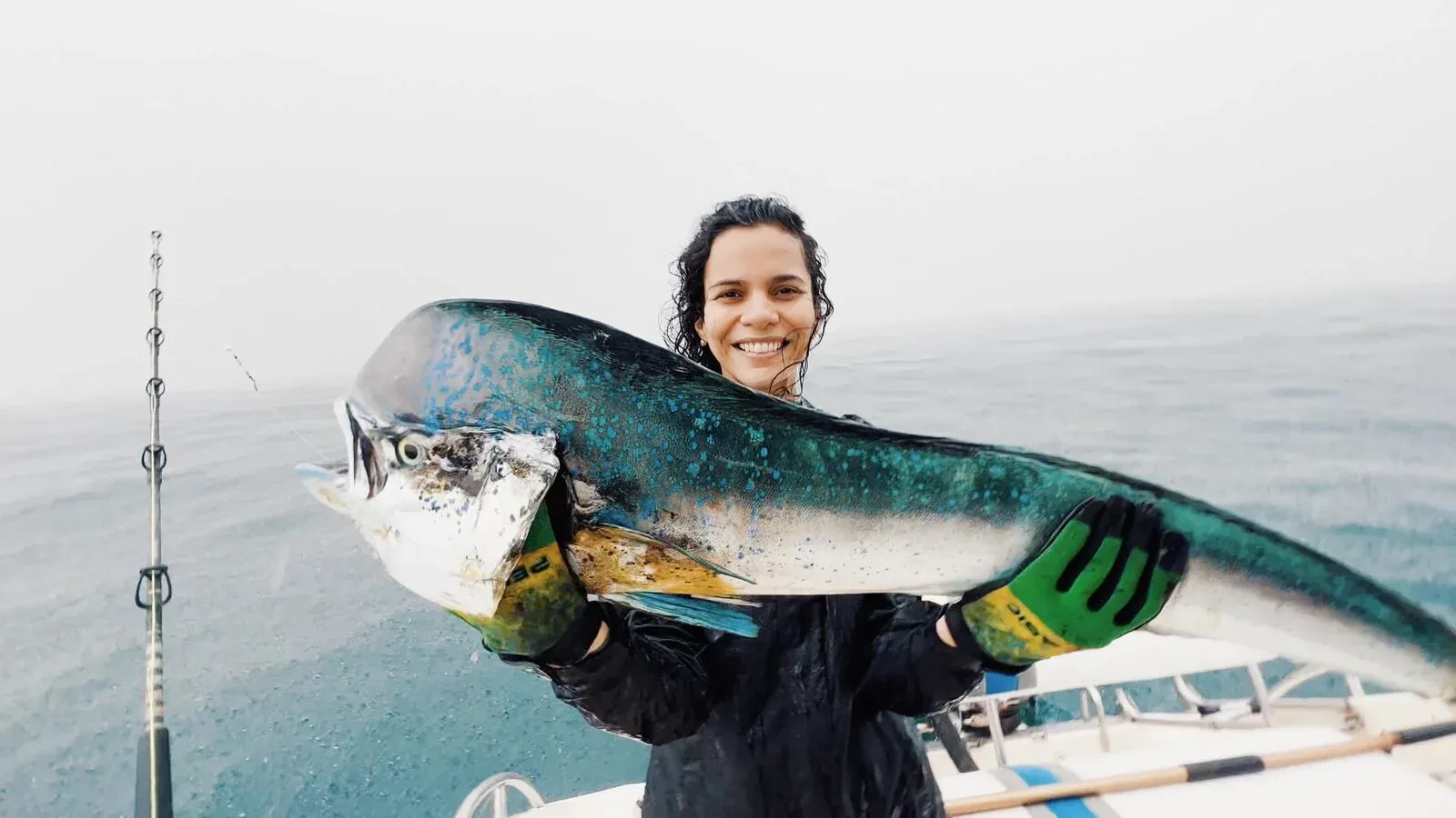 Angler holding a mahi-mahi on a sport fishing boat off the Pearl Islands