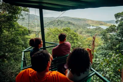 Guests riding the aerial tram above the Gamboa rainforest canopy