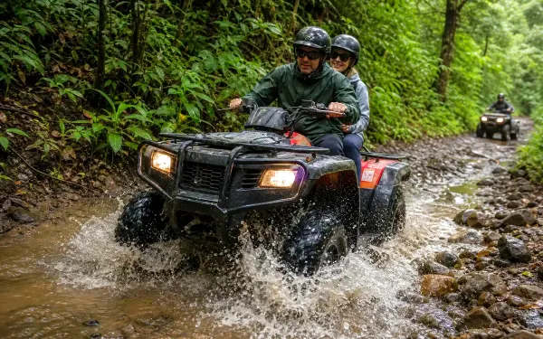 ATV riders splashing through a shallow Cerro Azul stream crossing
