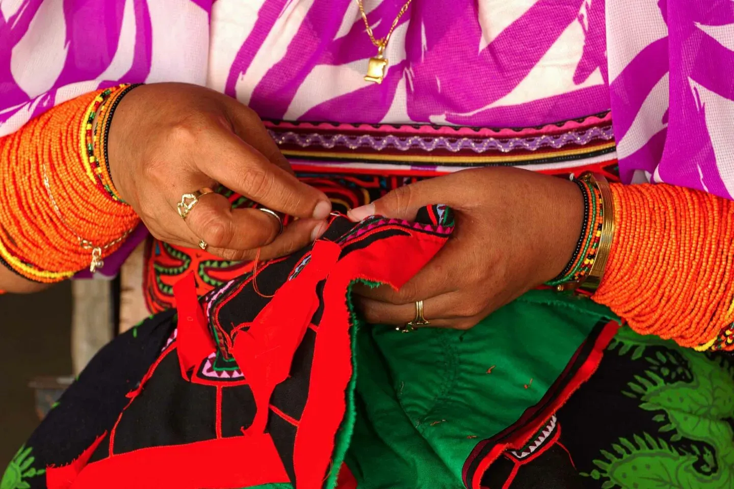 Artisan Guna cousant un textile mola coloré